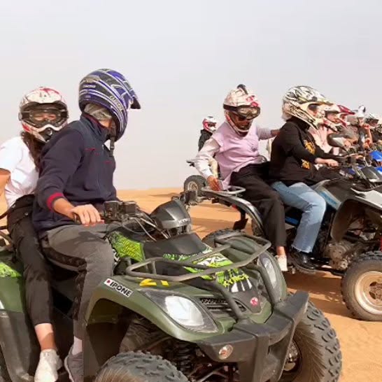 A group on quad bikes in the dunes